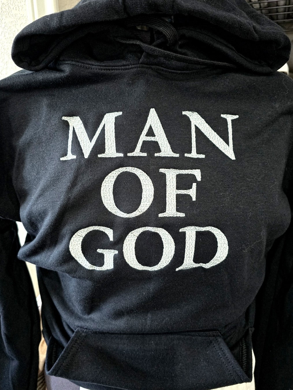 MAN OF GOD white embroidered hoodie back view in black