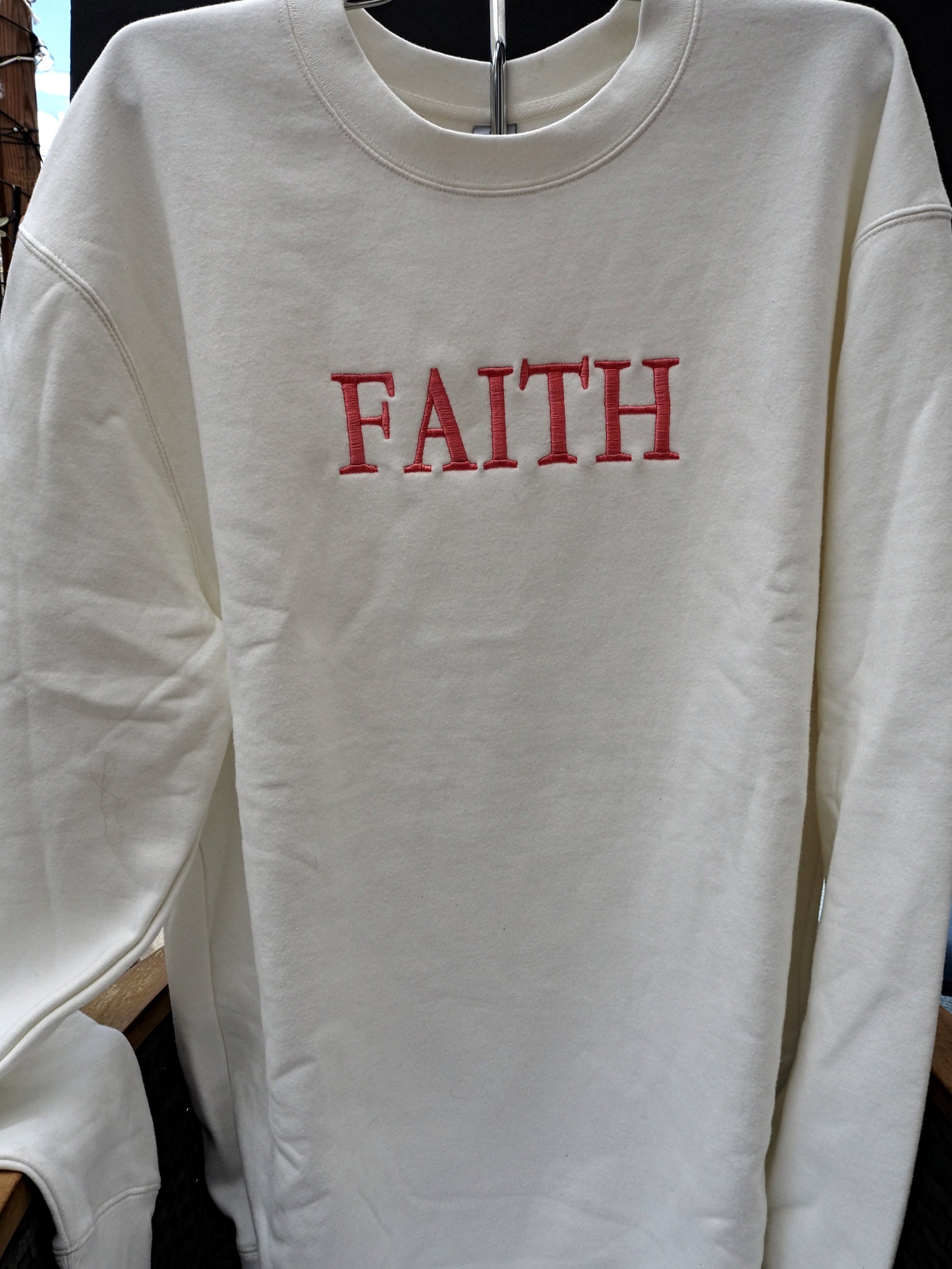 FAITH embroidered crewneck sweatshirt in cream white with red lettering
