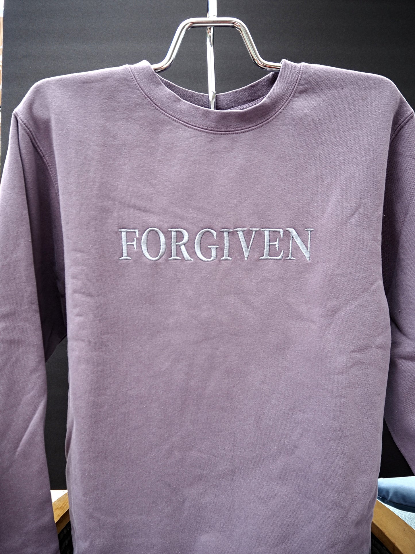 FORGIVEN embroidered crewneck sweatshirt in dusty mauve with white tonal lettering