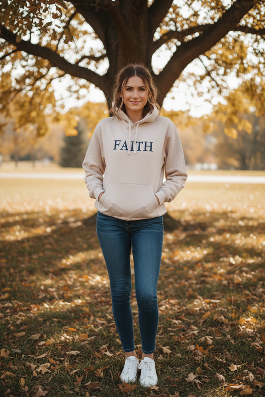 Lifestyle photo of woman wearing sand FAITH hoodie outdoors